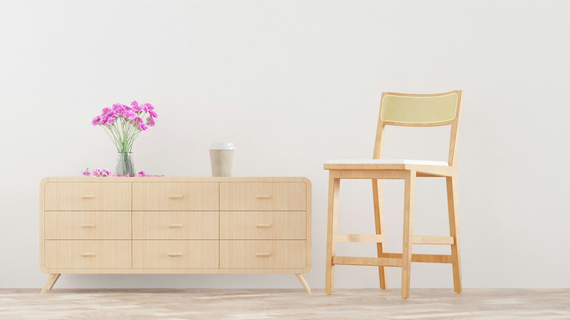 a chair and a dresser with a vase of flowers on it
